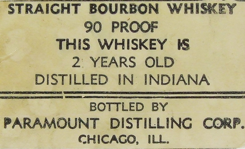 Label showing text from an old whiskey bottle stating it's a 'straight bourbon whiskey' and has been aged for two years according to 1938 law